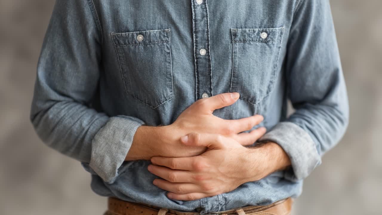 A Man Expressing Discomfort with Hands on Stomach and Transitioning to Open Gestures, Captured in Two Distinct Frames Highlighting His Body Language