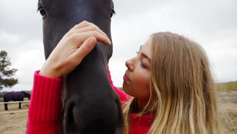 Woman-kissing-horse-in-ranch-4k