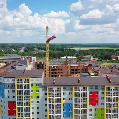 construction site of a modern district. tower crane build new high-rise buildings on nature background. residential complex is building. drone view
