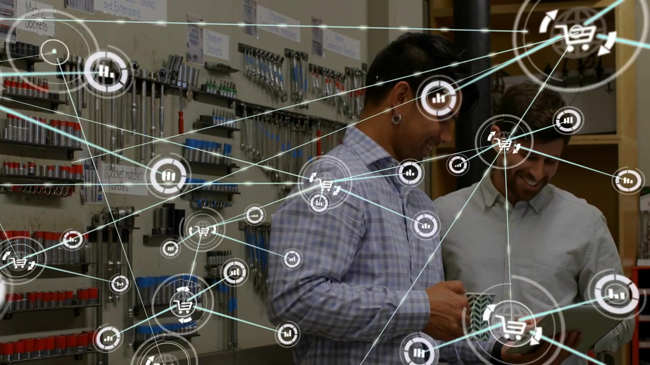 Two men studying tablet in workshop, right man tapping, HUD expanding and visualizing sales data
