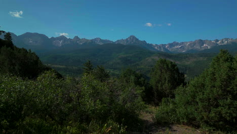 Colorado-scenic-summer-San-Juans-Rocky-Mountains-aerial-drone-cinematic-Ridgway-Ralph-Lauren-Ranch-Mount-Sniffels-Dallas-Range-14er-Million-Dollar-Highway-view-morning-bluesky-forward-movement