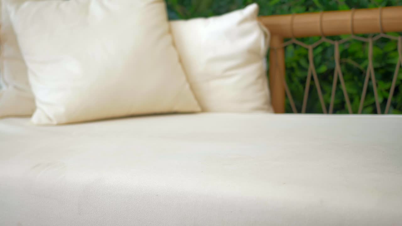 Woman Holding a Brown Leather Handbag on a Light Beige Sofa