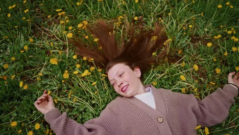 girl relaxing in a field of dandelions