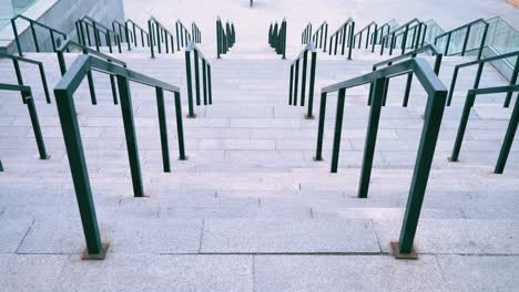 wide staircase made of concrete, with black iron railings railings, large staircase to the football stadium