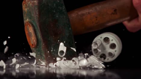 hammer smashing a light bulb