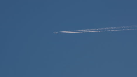 airplane in the sky with contrails