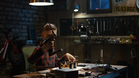 boy working on a radio-controlled car in a workshop