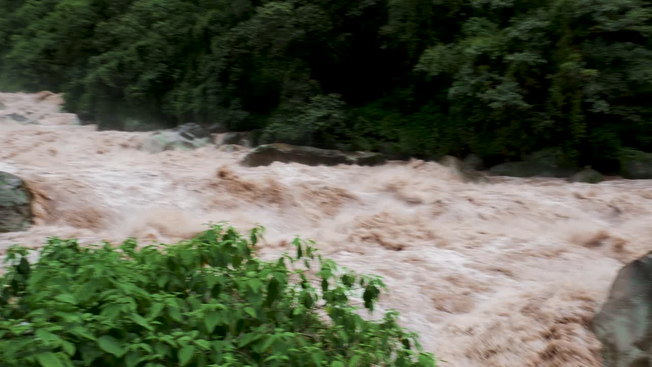Rapids near Aguas Calientes village after tropical rain, Peru