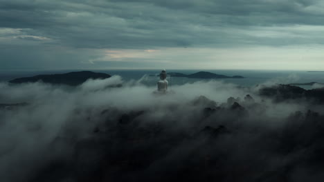 majestic buddha statue amidst misty mountains