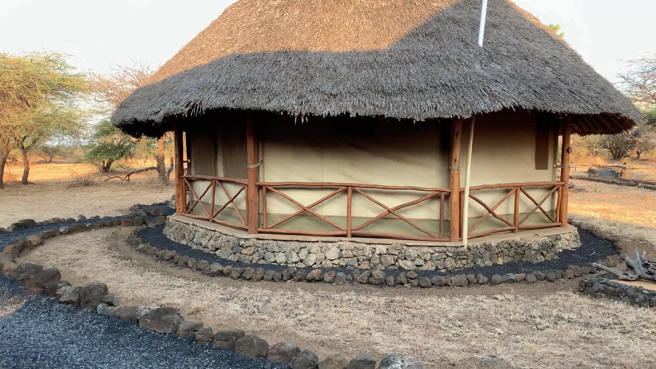 Beautiful small lodge hut in Kenya Africa with winding, stony, paths and amazing rustic design - style. Cottage in wildlife park in Kenya, Africa.