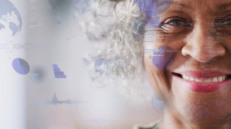 Senior woman widening smile while blue charts drifting over cheek from left, showing business data