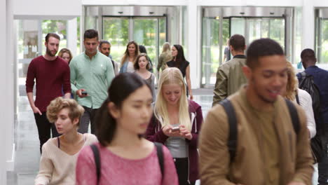 Students walking through the foyer of a modern university, shot on R3D