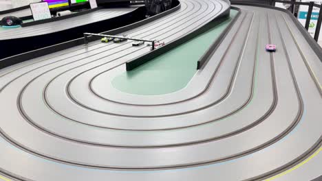 miniature cars racing on a multi-lane track