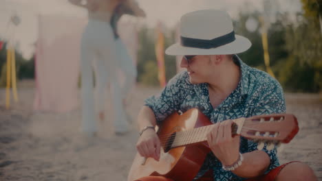 happy man playing acoustic guitar while couple dancing bachata