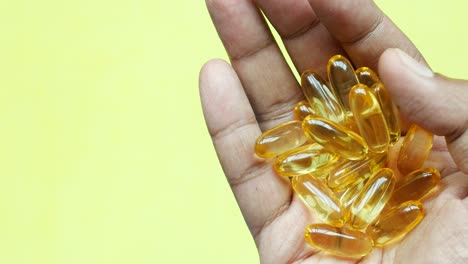 fish oil supplement on hand top view