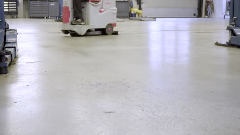 Cleaning-floor-with-automatic-washing-mashine-at-car-workshop