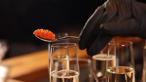 serving red caviar with champagne