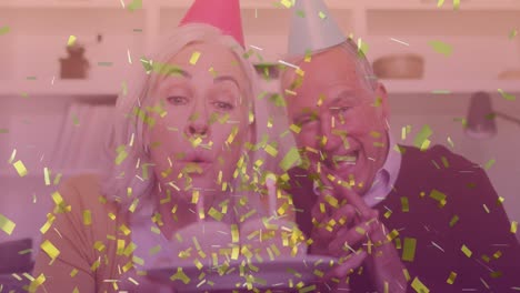 composite video of golden confetti falling over caucasian senior couple celebrating birthday