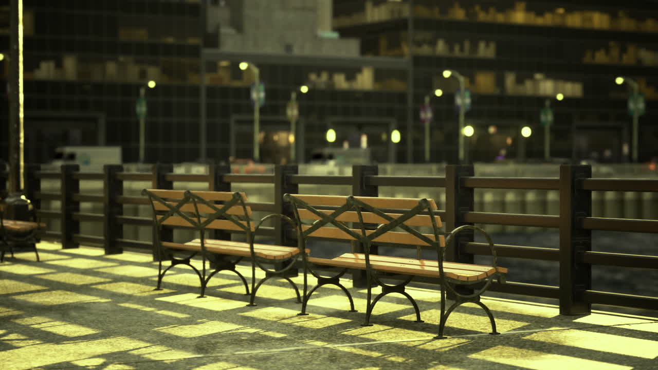 Park benches lining a waterfront promenade at night with city lights glowing