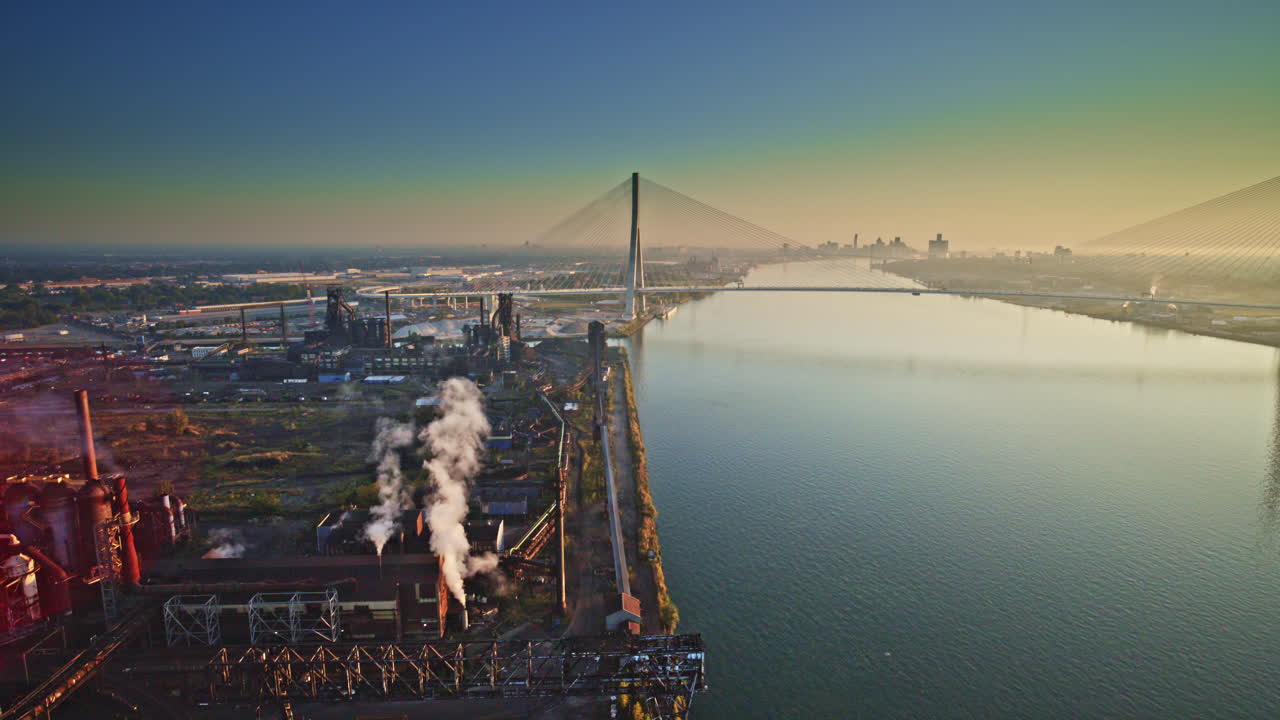 Wide aerial shot of the Detroit River with industry close by