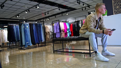 man browsing clothing in a modern fashion store