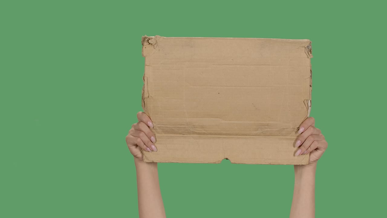 Protest banner copy space. Female hands are holding blank cardboard. Advertising platform. Isolated a green screen, chroma key. Close up. Slow motion