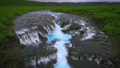 Drone-aerial-view-of-Bruarfoss-waterfall-in-Brekkuskogur,-Iceland.