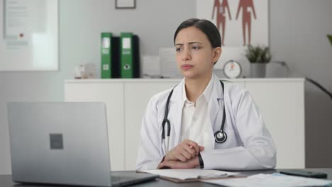Serious-Indian-female-doctor-consulting-patient-on-video-call