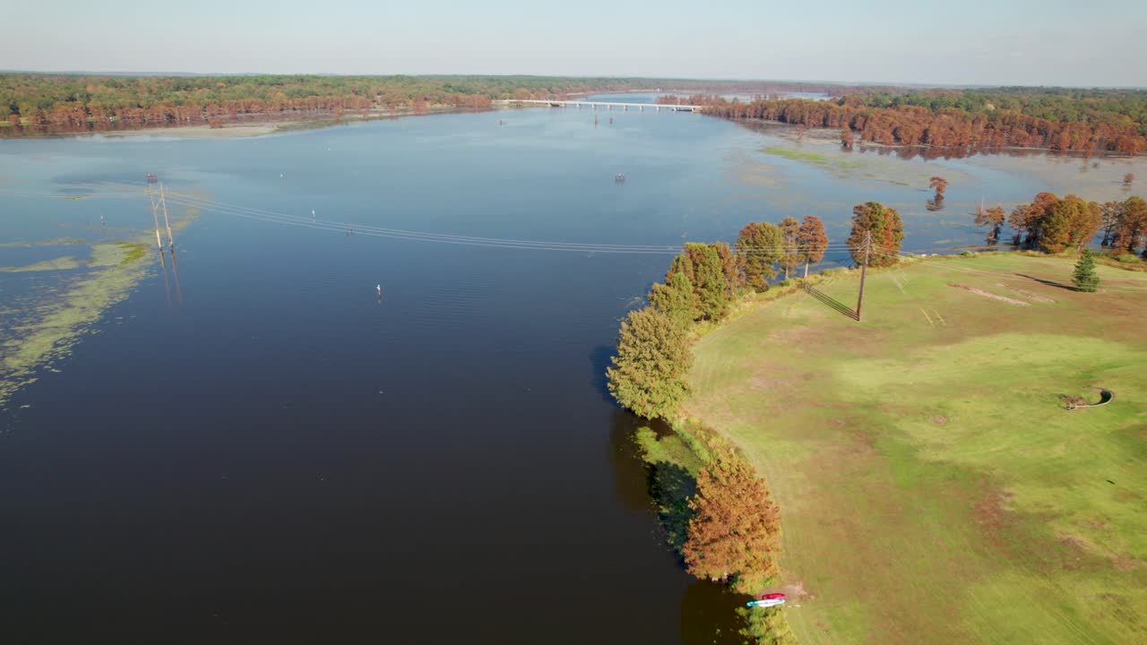 Aerial footage of Lake Caddo on Louisiana side. On the left is a shoreline with trees