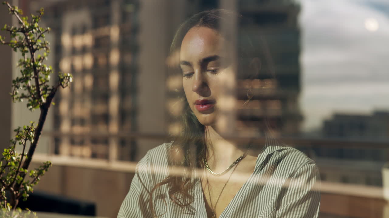 A woman reflected in a window