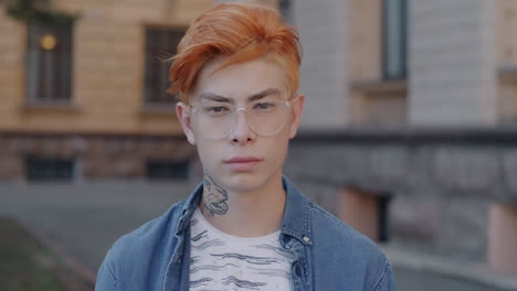 young man with red hair and glasses