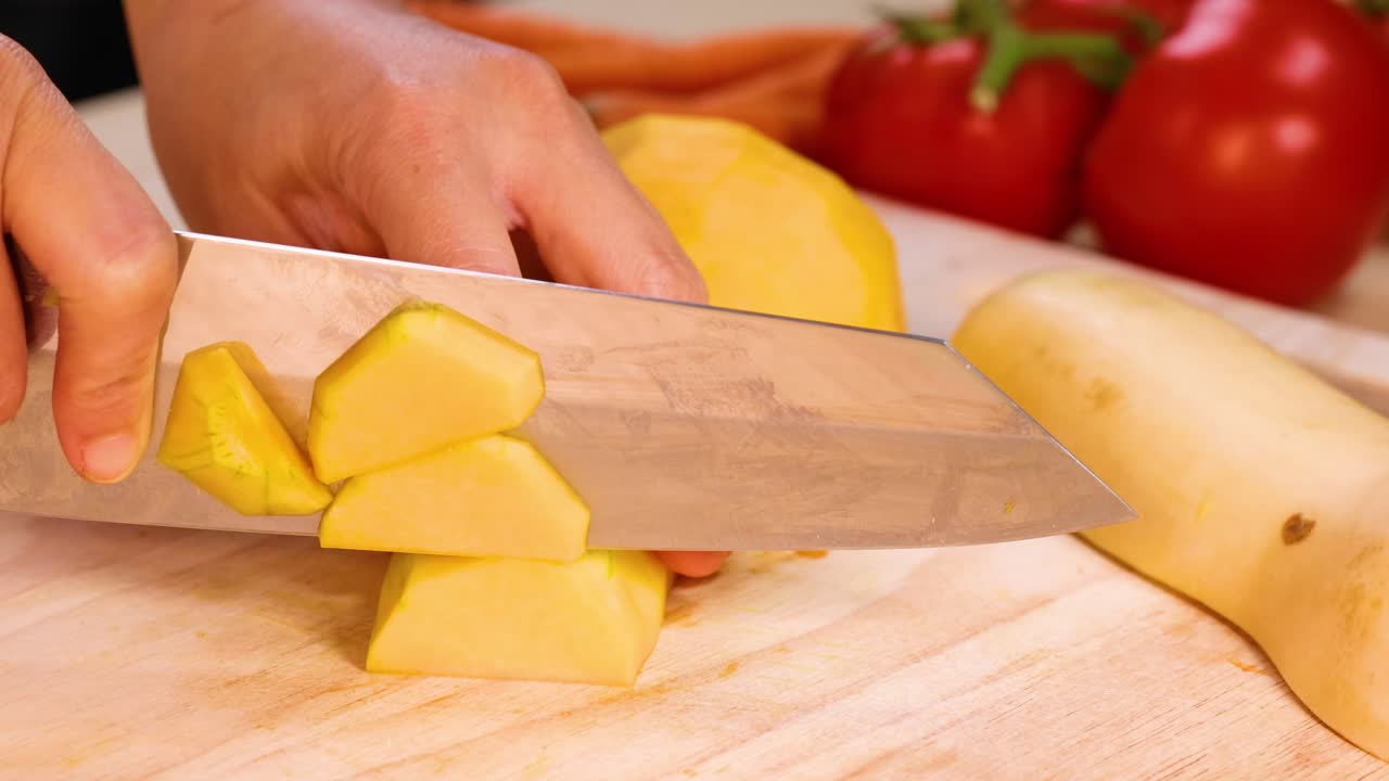 manos cortando calabazas con tomates en el fondo