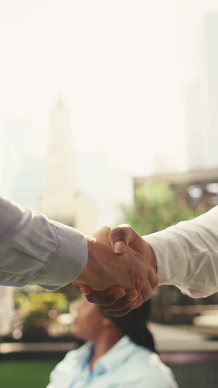 Vertical Video Close up of business partners shaking hands after one on one negotiation