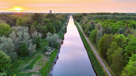 serene sunset by the river. a serene sunset reflects on a calm river lined with dense trees, showcasing nature's beauty in tranquility