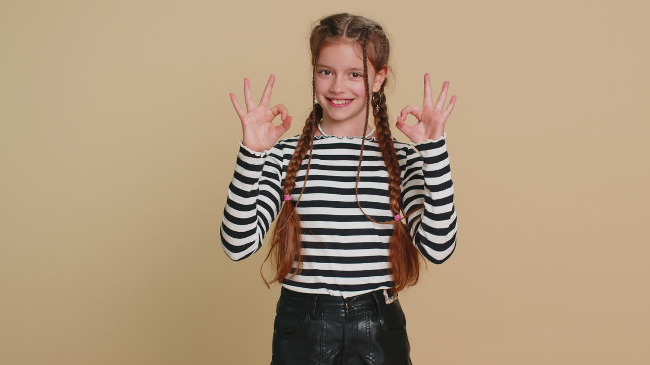 Happy child girl kid showing ok gesture like sign positive feedback celebrate victory approve idea