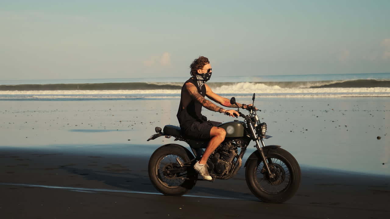 Man Riding Motorcycle on a Beach