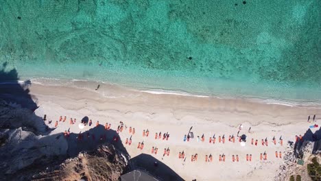 Mirror-Beach-and-Clear-Blue-Ionian-Sea-in-Ksamil,-Albania---Ascending-Overhead