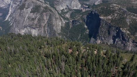 aerial reverse pull-back and tilting up shot of yosemite valley from glacier point