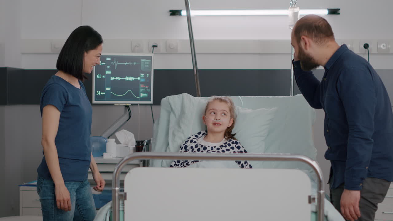 Happy family giving high five to little girl daughter recovering after clinic therapy