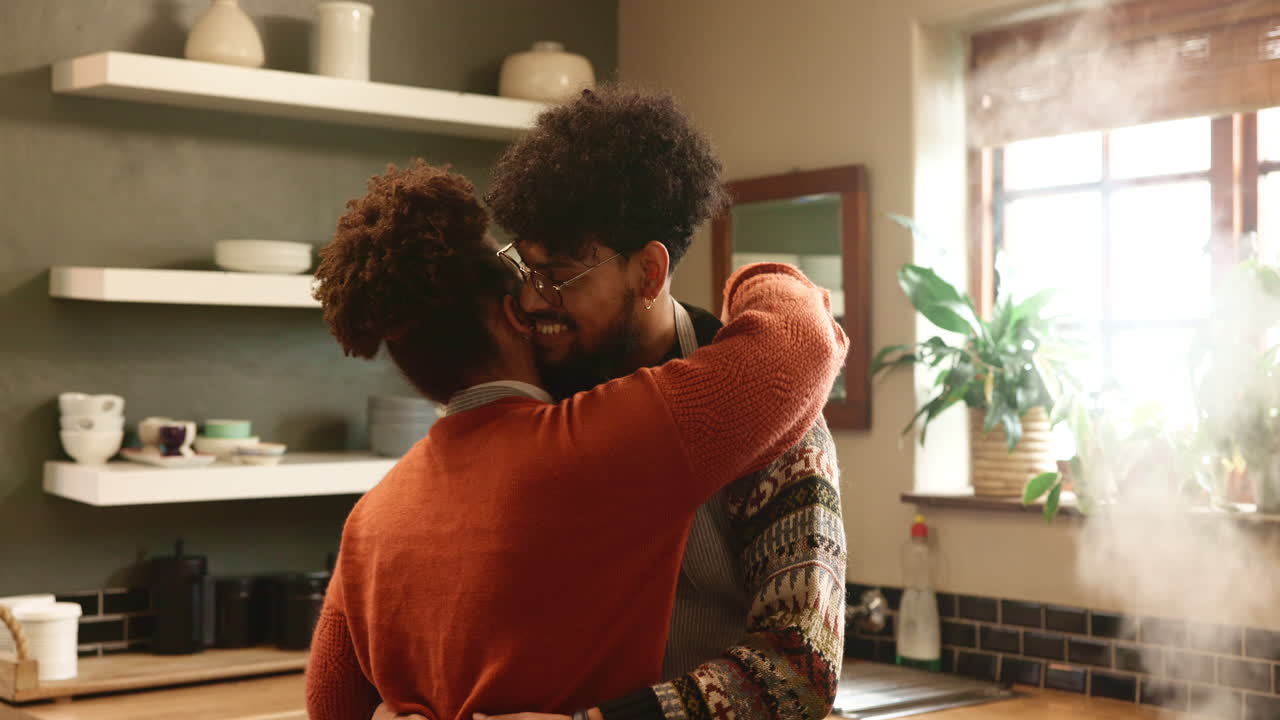A young couple hugging in the kitchen