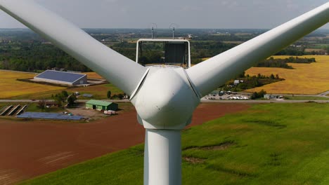 wind turbine rotor cone with propellers from an aerial dolly drone shot for close up inspection