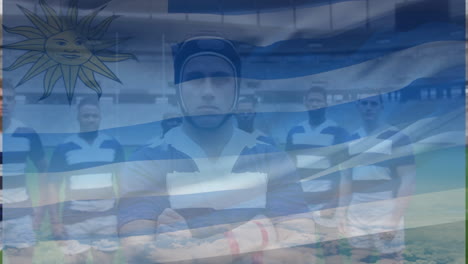 animation of uruguay flag over team of diverse male rugby players standing together at rugby field