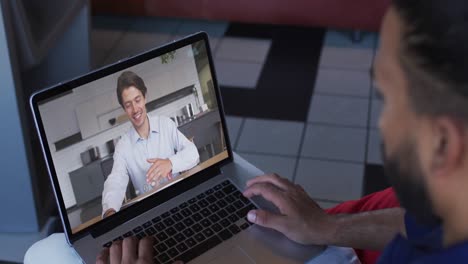 Middle-eastern-man-having-a-video-call-with-male-colleague-on-laptop