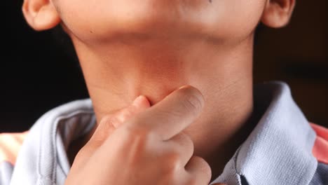 boy suffering throat pain close up