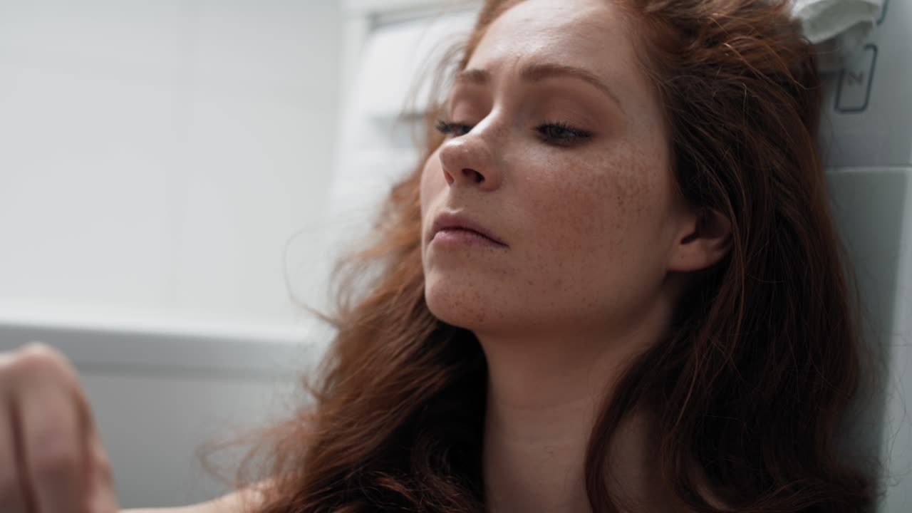 Caucasian woman in bathroom waiting for result of pregnancy test.