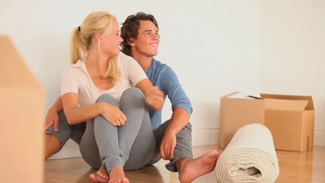 happy couple sitting on the floor