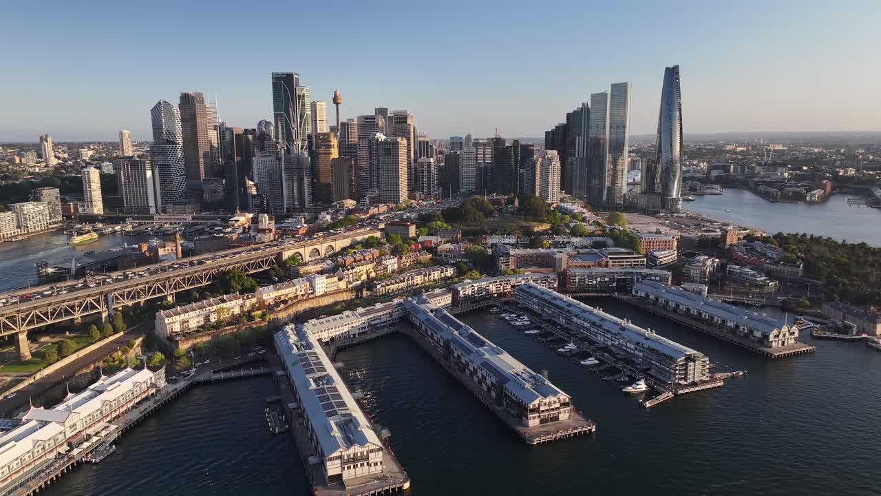 The Rocks Suburb with old dock buildings and Sydney downtown skyline. Aerial birds eye.