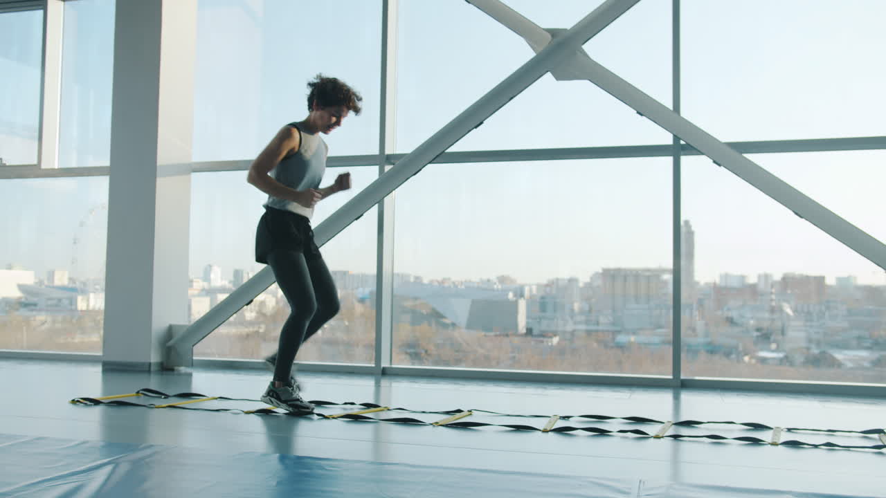 Person Doing Agility Ladder Workout in Modern Gym