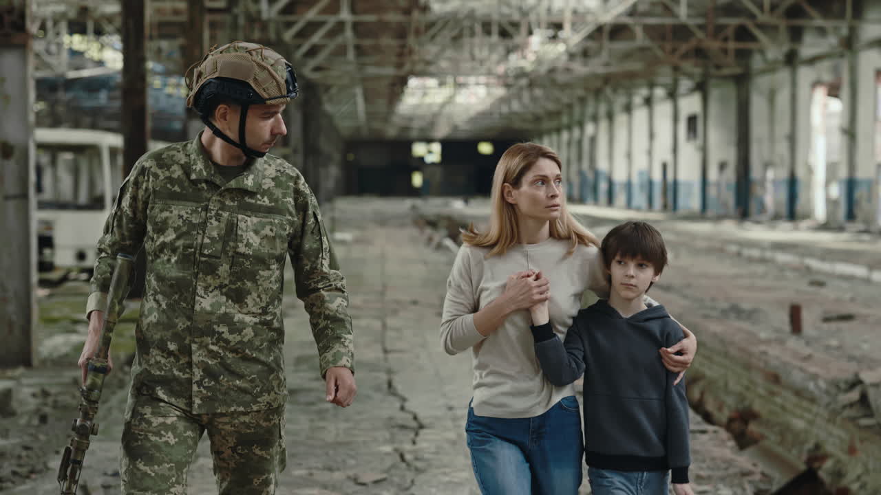 Soldier Assisting a Family in a War-Torn Area