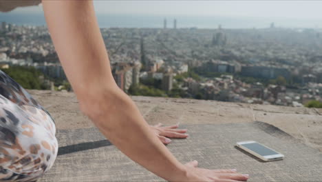 woman looking video on smartphone screen during yoga training outdoors